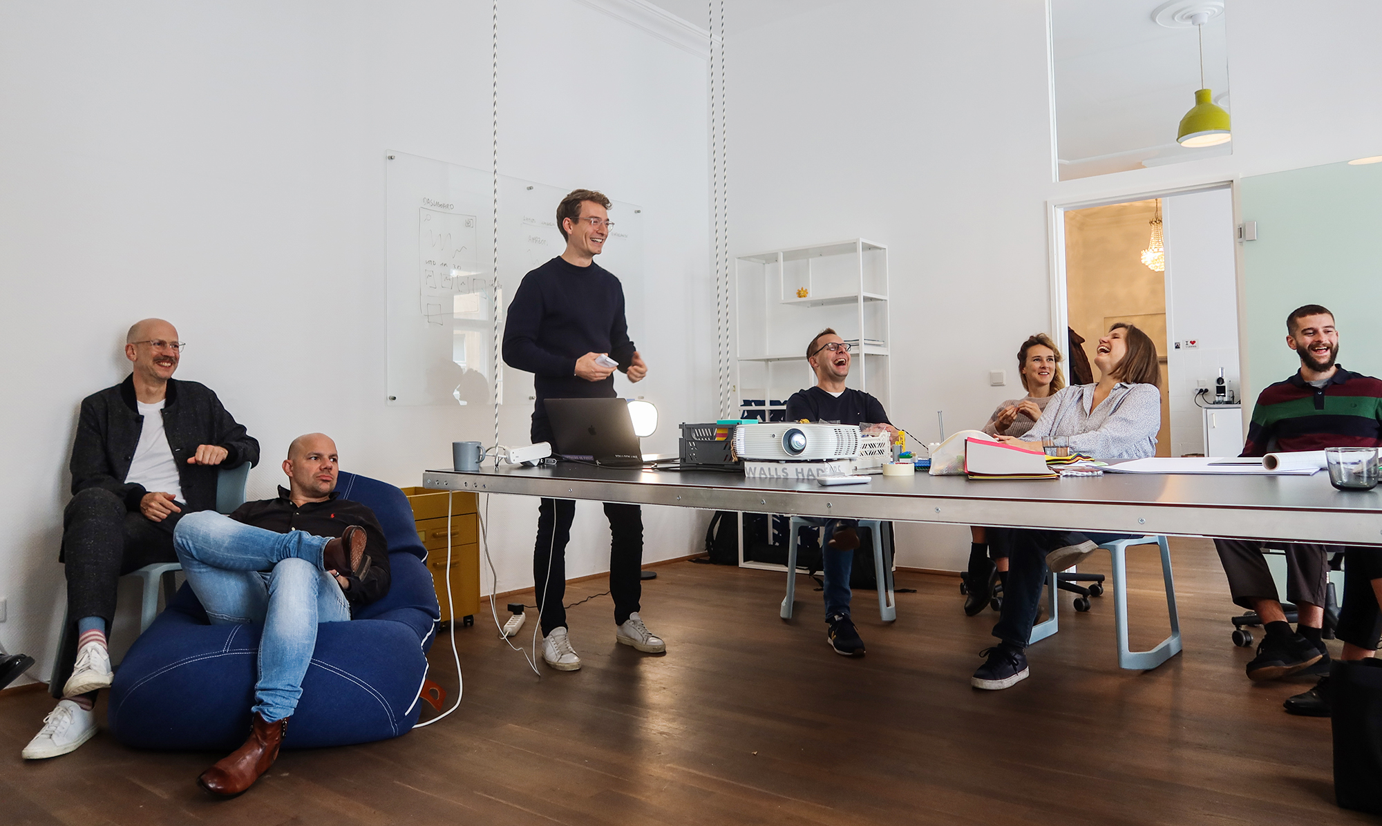 The Berlin and Austrian ENNOstudio Teams laughing together at the office in Kreuzberg