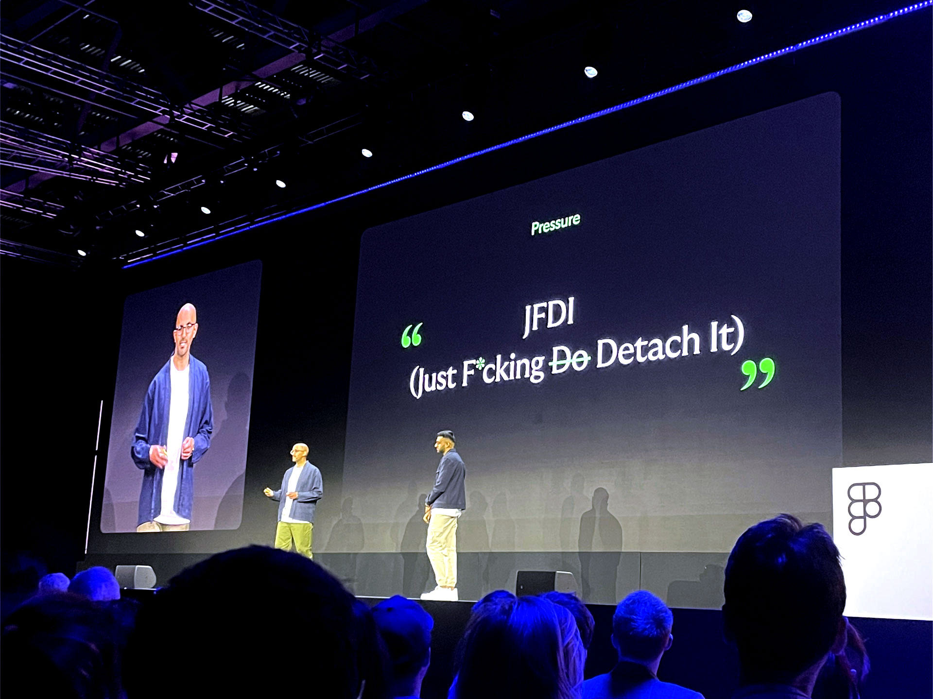 Vishal Kapoor and Kishan Koriya from Lloyds Banking Group standing on a big stage behind them a big screen saying "JFDI Just Fucking detache it"