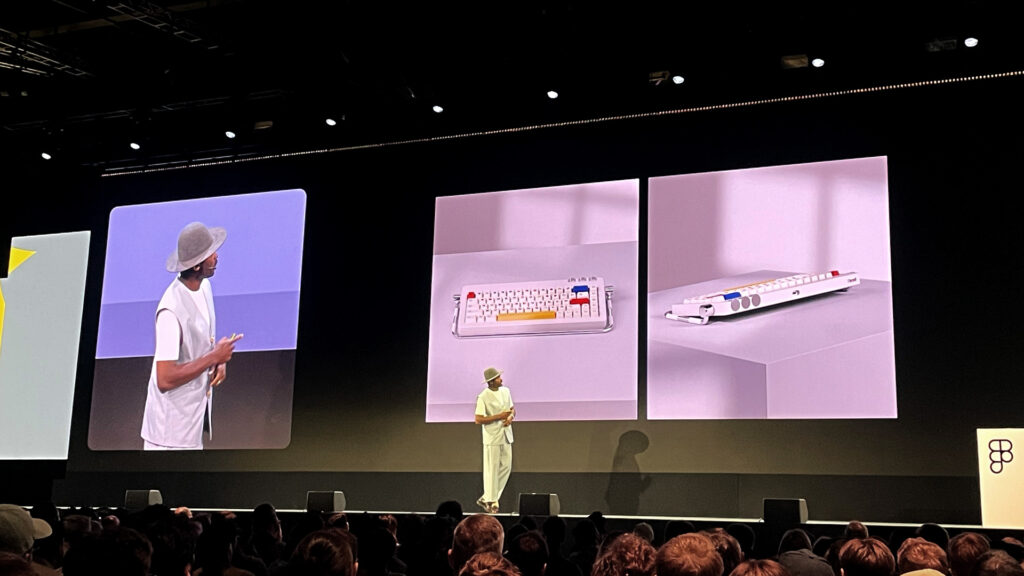 Timothy Achumba, Principal Design Director at Microsoft standing on a big stage behind him a screen showing his designs of a keybord inspired by bauhaus